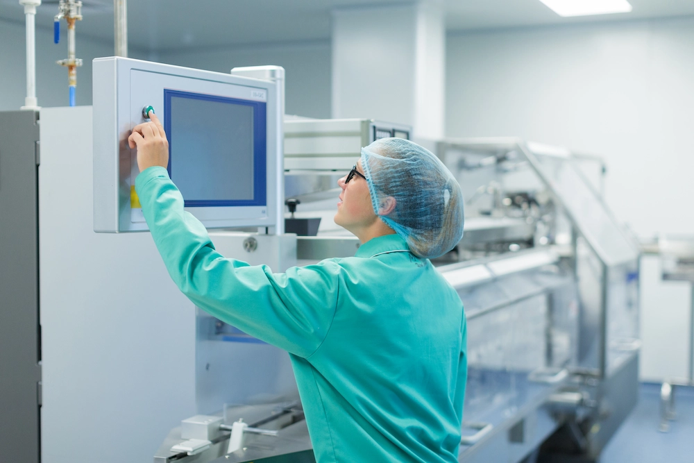 Medical device assembly worker inspecting recent product.